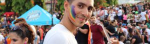 man-with-pride-flag-smiling