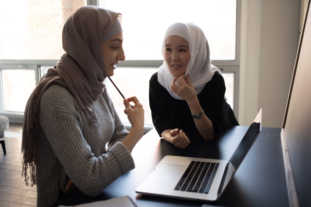 Two women with hijab talking